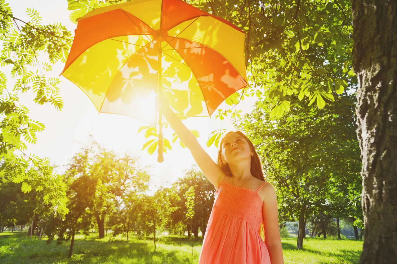 Young girl holding umbrella